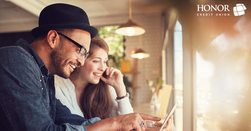 Honor members can check their VantageScore credit score in Online Banking for free; man and woman looking at computer screen