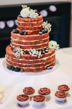 wedding cake with white frosting sitting on a table