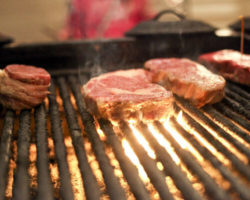 photo of steaks on a grill at the grill house in allegan, michigan