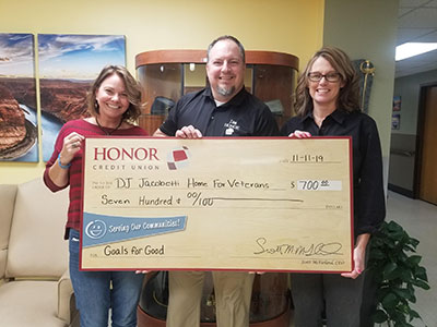 image of jamie gollakner from honor credit union presenting a check to the jacobetti veterans home