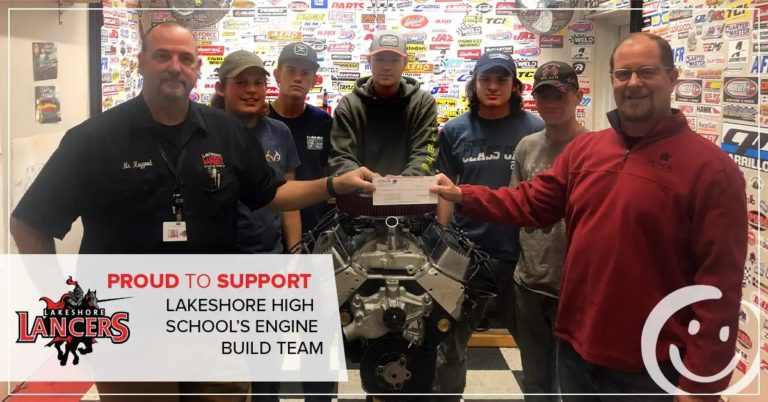 photo of lakeshore high school's engine build team being presented a check by honor credit union ceo scott mcfarland